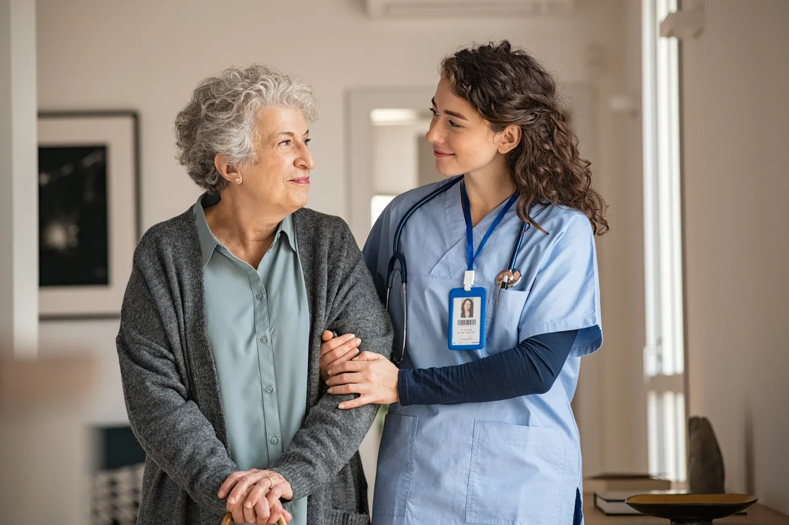 Aide-soignante accompagnant une résidente dans un EHPAD